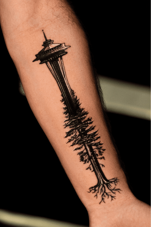 Seattle Space Needle growing into a rooted pine tree, blackwork forearm tattoo