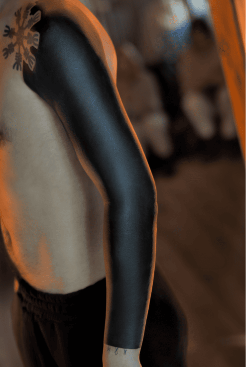 Solid black blackout sleeve covering the full arm