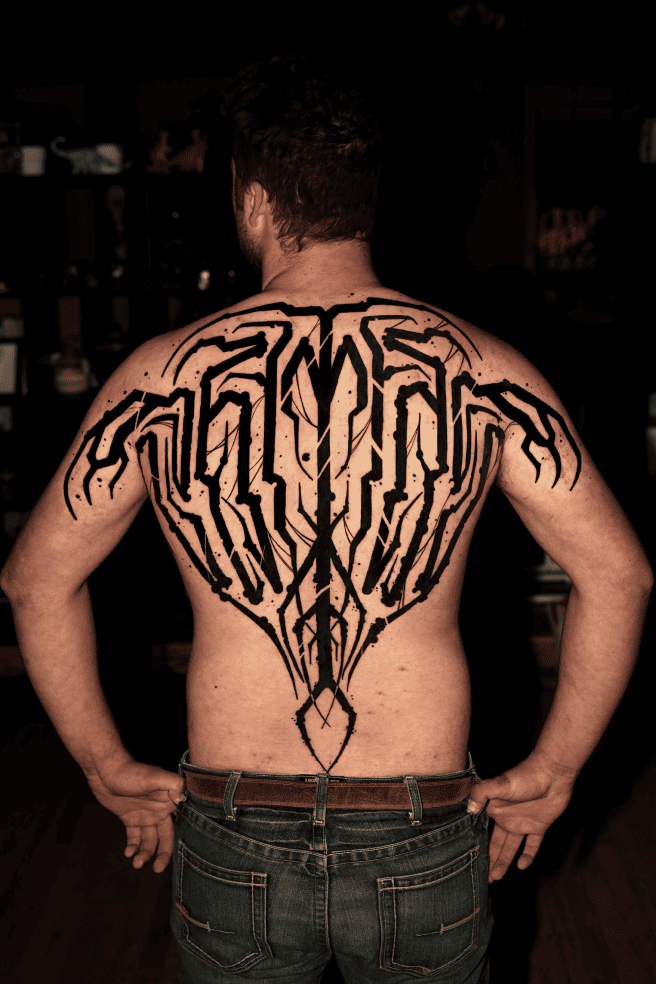 Large abstract blackwork ornament covering the full back and shoulders